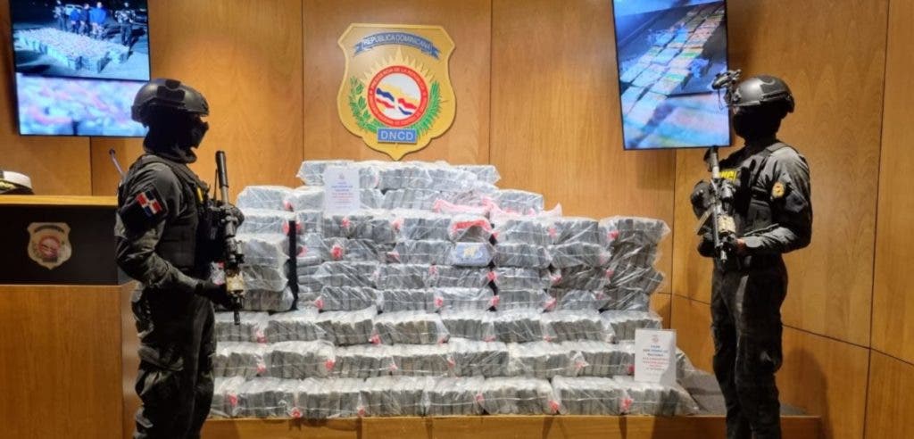 Dos agentes de la DNCD custodia los 810 paquetes de cocaína incautados este lunes en SPM