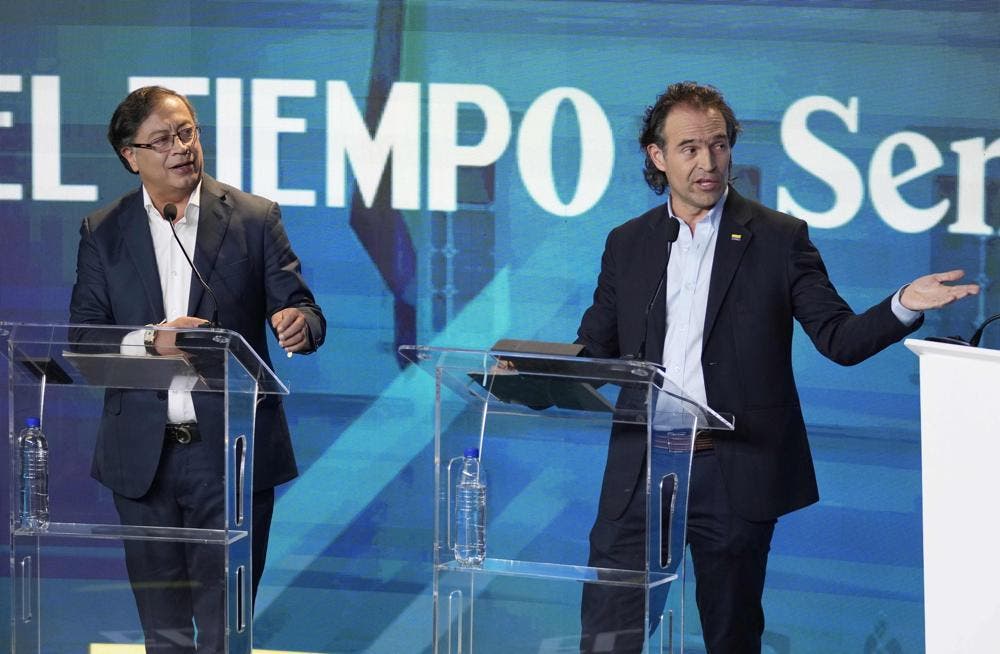 Federico Gutiérrez, candidato presidencial que representa a la coalición Equipo por Colombia, derecha, y el aspirante presidencial Gustavo Petro de la coalición Pacto Histórico, participan en un debate presidencial en el edificio del periódico El Tiempo, el lunes 23 de mayo de 2022, en Bogotá, Colombia. (AP Foto/Fernando Vergara)
