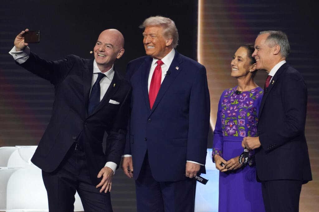 De izquierda a derecha, el presidente de la FIFA, Gianni Infantino, se toma una selfie con el presidente Donald Trump, la presidenta mexicana, Claudia Sheinbaum, y el primer ministro canadiense, Mark Carney, durante el sorteo de la Copa Mundial de fútbol de 2026 en el Kennedy Center en Washington, el viernes 5 de diciembre de 2025. (Foto AP/Evan Vucci)