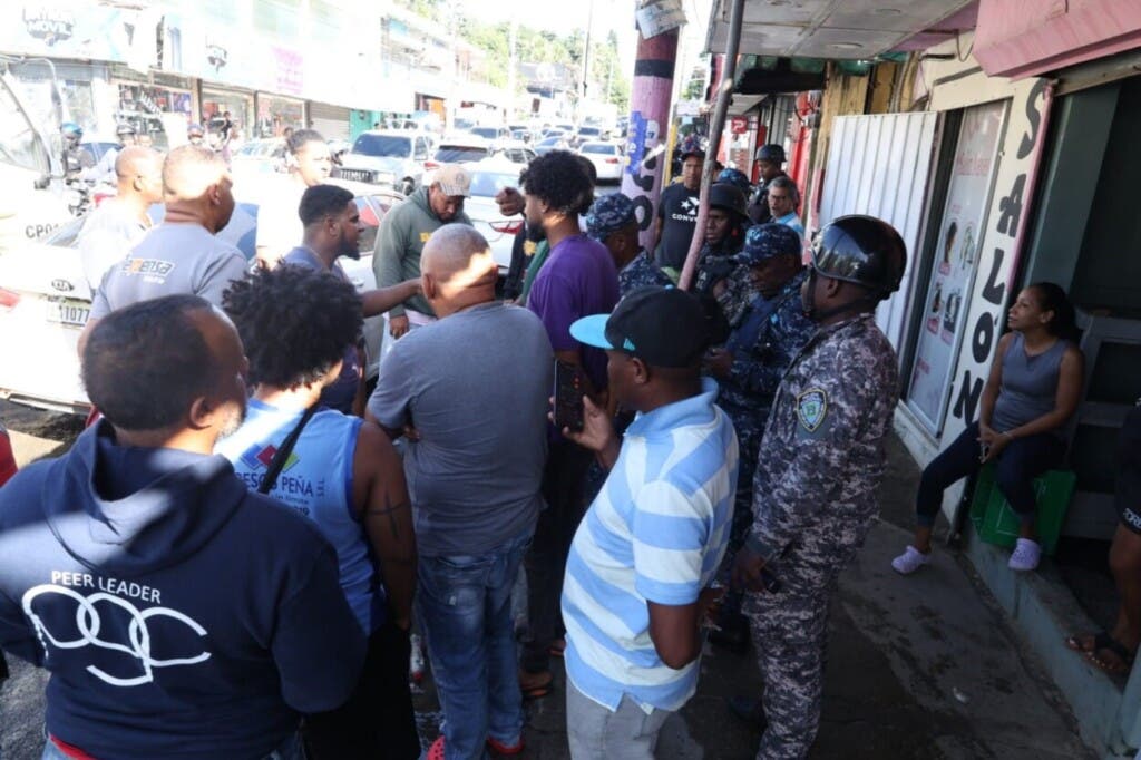Choferes de Los Girasoles que bloqueaban la avenida Monumental en reclama de la reparación de la vía conversan con agentes de la Policía./Foto Guillermo Burgos